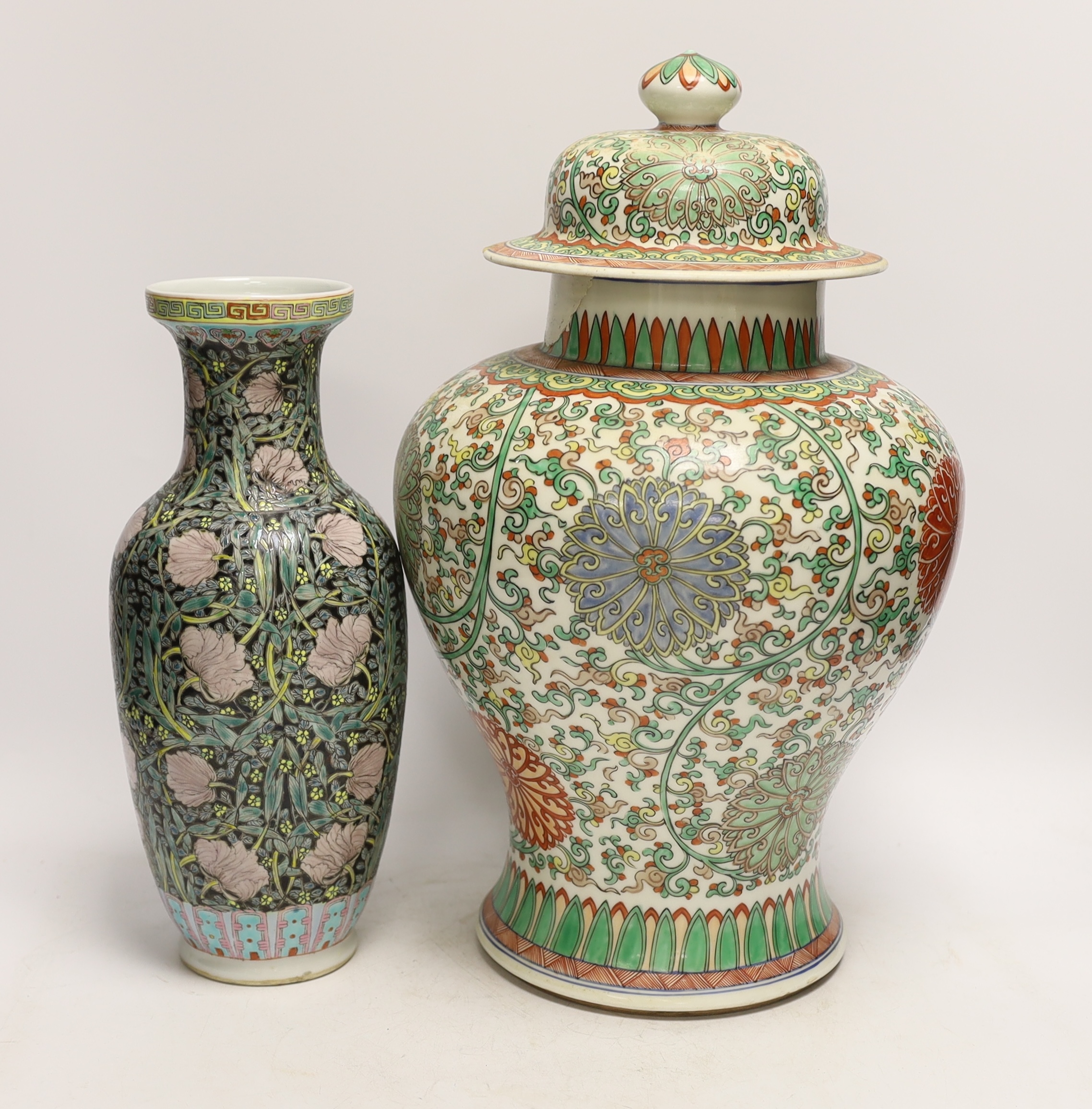 A large Chinese famille verte baluster jar and cover and a famille noir vase, tallest 40cm